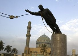 iraqis aided by US marine topple a huge statue of Saddam in main square in Baghdad